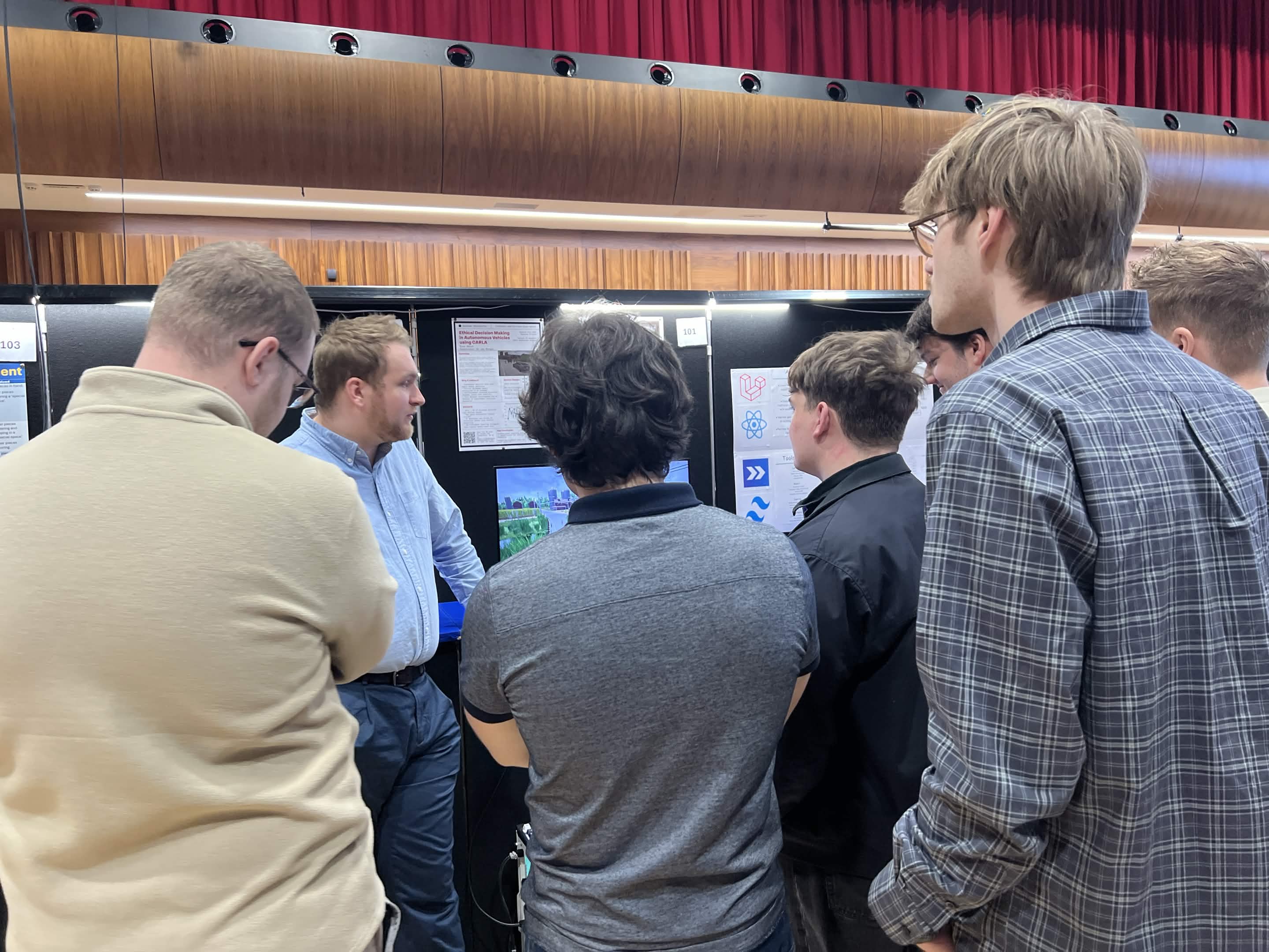 Ryan Smith discussing his dissertation project at a university project fair.